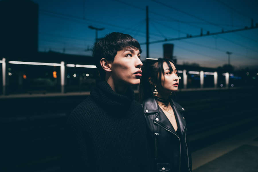 Couple with blank expression in train station, Milan, Italy