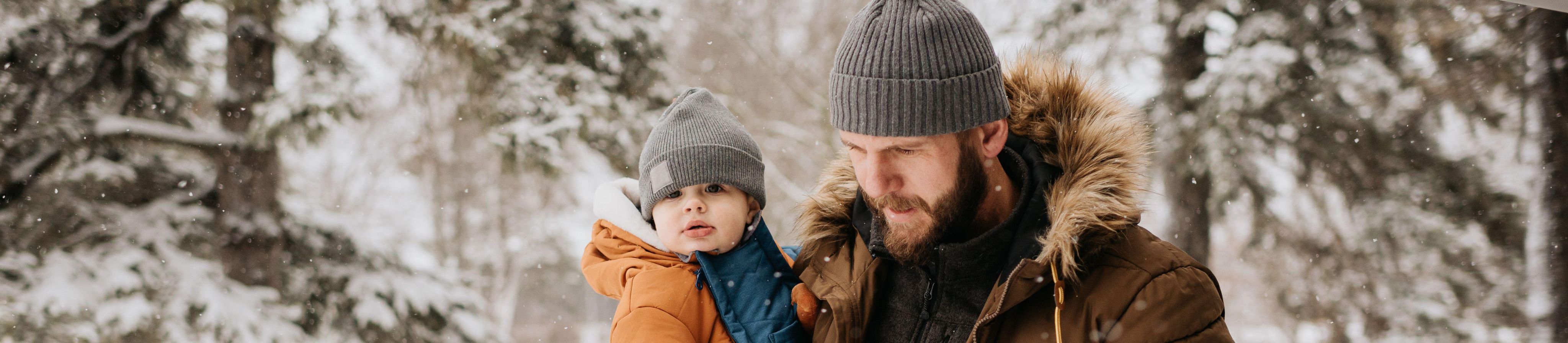 Canada, Ontario, Father holding baby boy on winter day - Image ID: 2FKD3JE (RF)