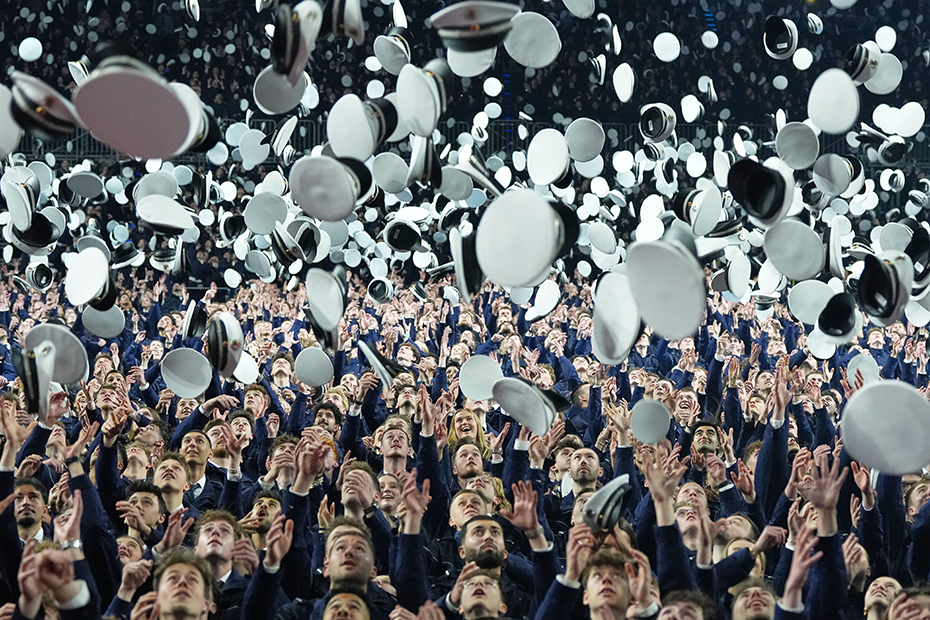 New young German police officer trainees throw their hats in the air after taking their oath of service and officially entering the service for security, law and democracy in Cologne.
